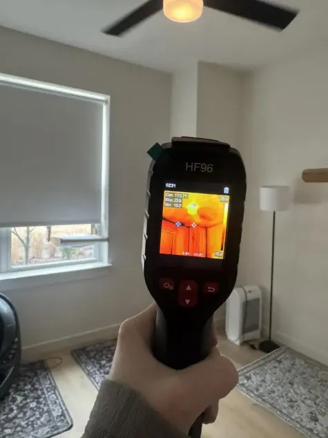 Mold assessor using moisture meter on Sarasota home wall during inspection